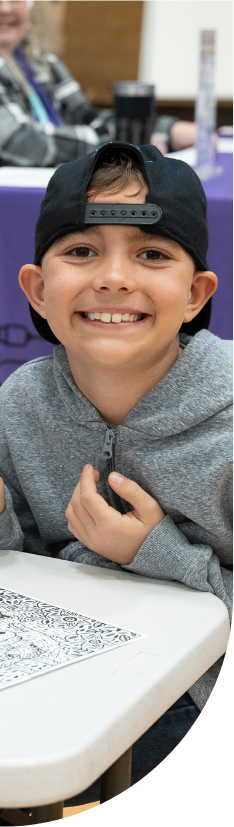 Young boy in a baseball cap smiling